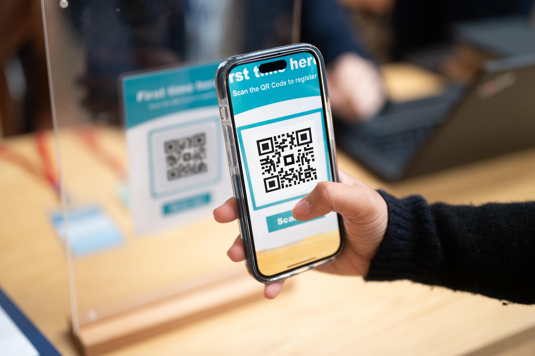 Smartphone scanning a QR Code at a conference