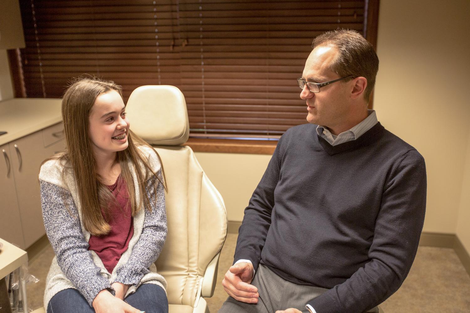 Teenager talking to an Orthodontist