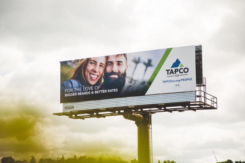 TAPCO Credit Union billboard with a dramatic evening sky background